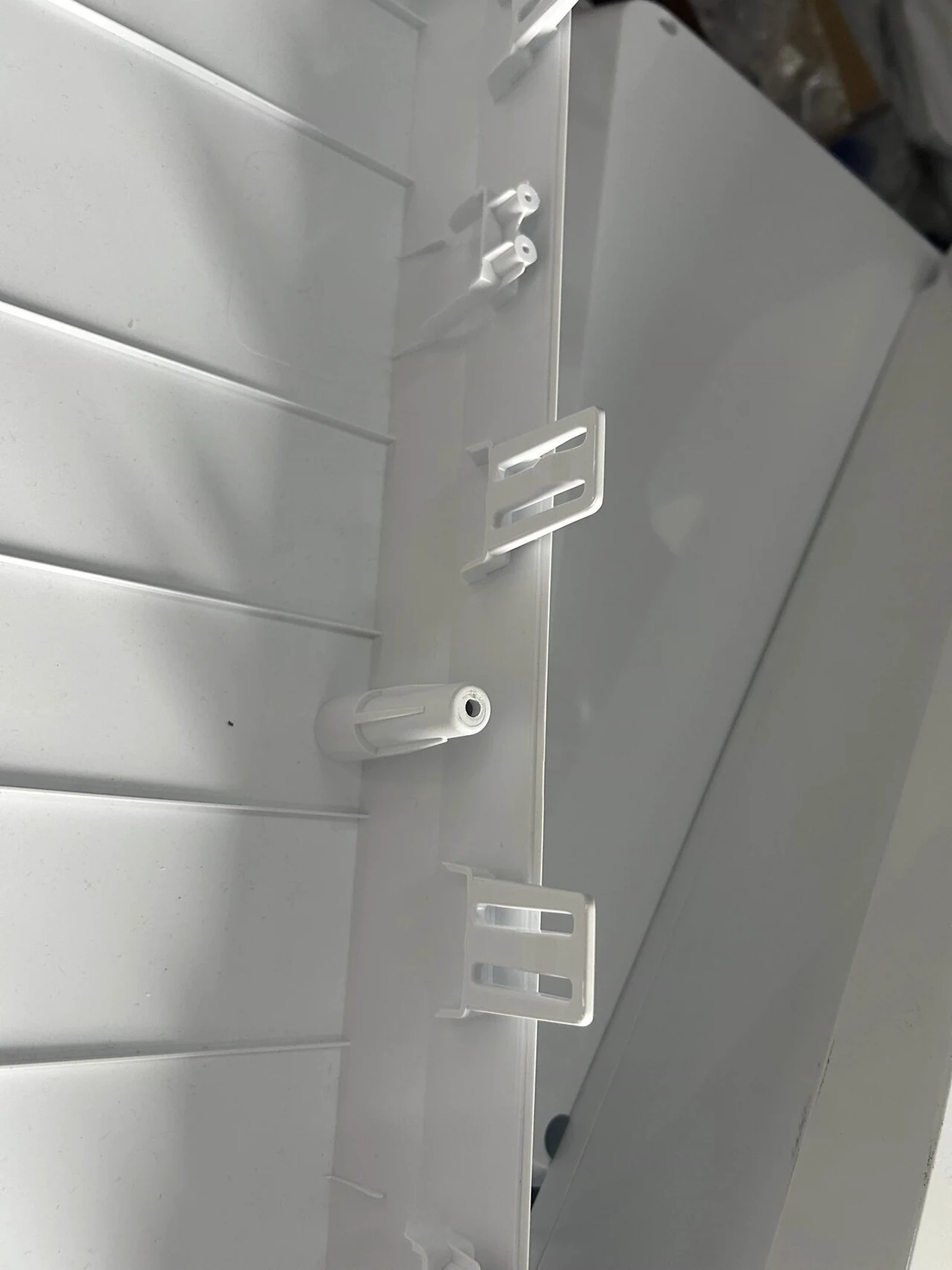 Internal clips, screw bosses, and reinforcing ribs in a plastic enclosure